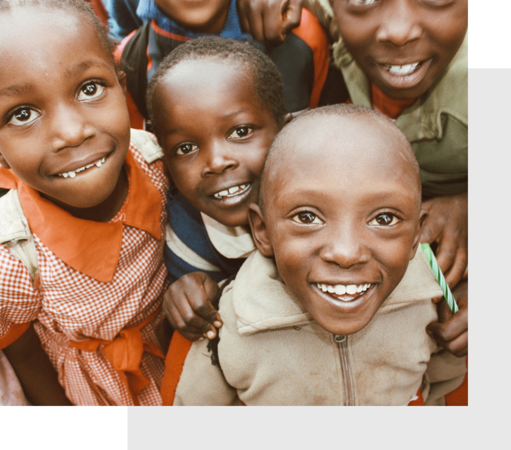 closeup of a group of kenyan children smiling and looking curious